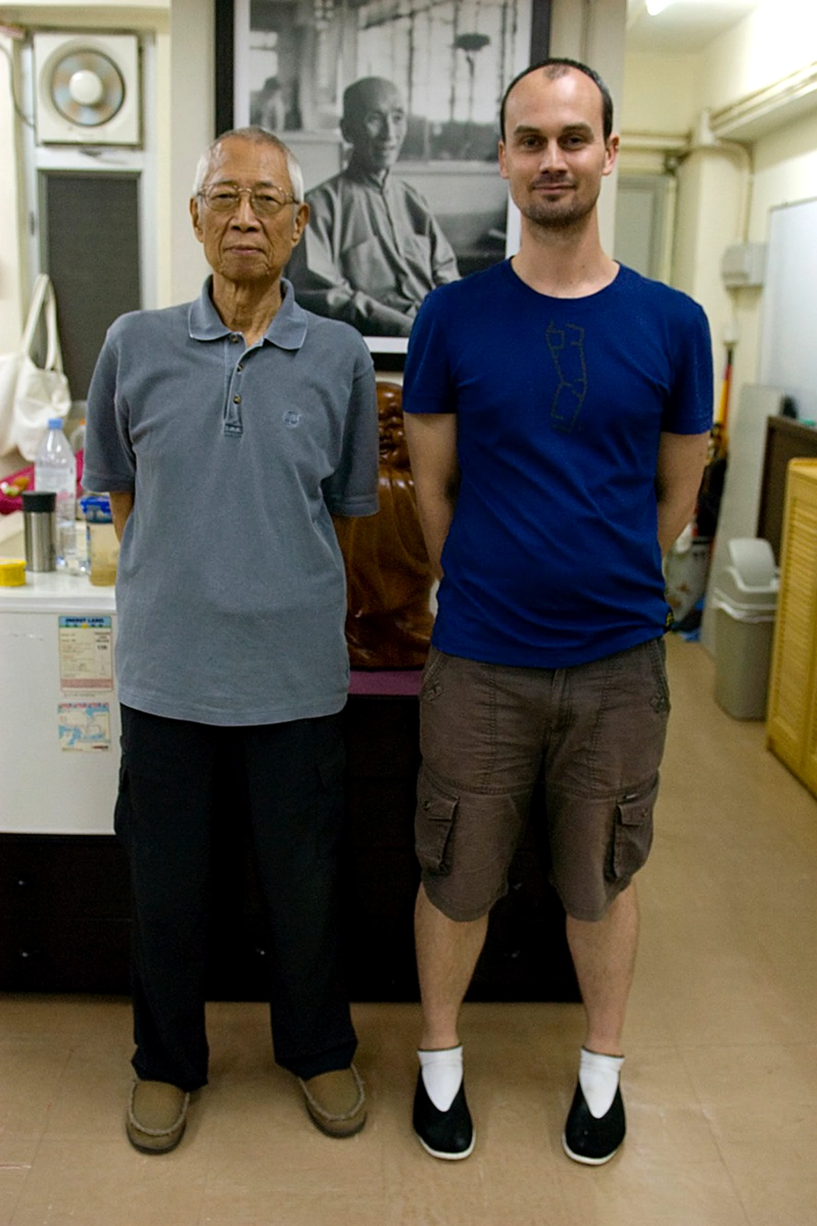 Phillip Warburton with Sigung Chu Shong Tin, beneath a portrait of Yip Man